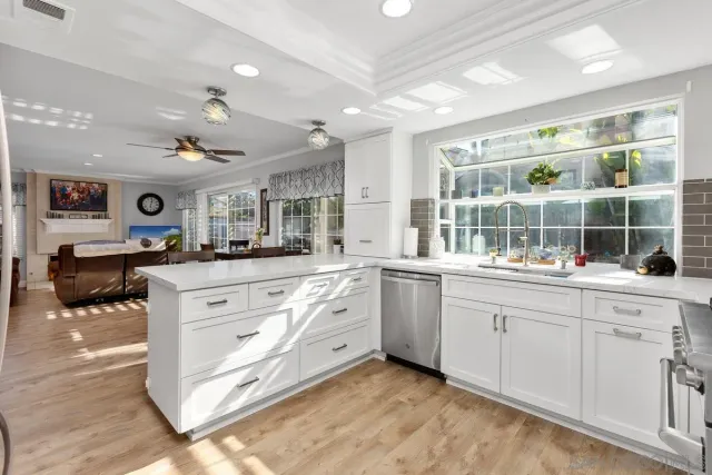 a kitchen with granite countertop a stove and cabinets