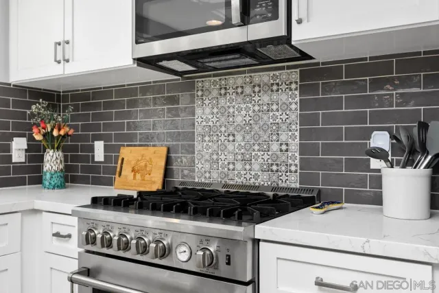 a stove top oven sitting inside of a kitchen