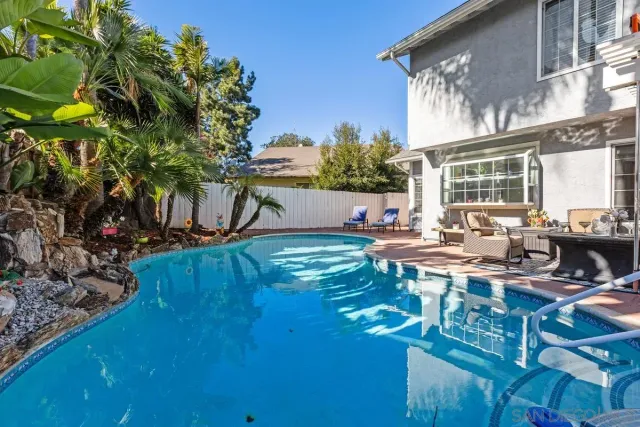 a view of backyard of house with outdoor seating