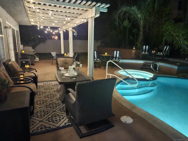 a view of a patio with couches chairs and a fire pit