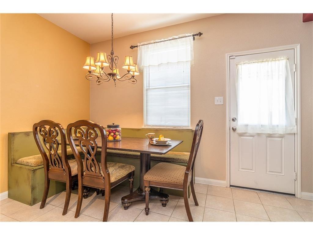 1009 Hawthorne Road Anna, TX 75409 - Photo 6 of 22 Dining area featuring built-in bench seating, ceramic tile flooring, a window with blinds, and an exterior door
