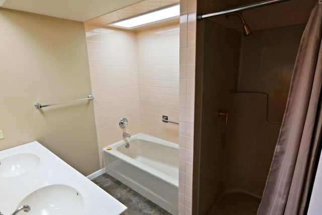 3516 Lily Pond Road Woodstock, IL 60098 - Photo 15 of 20 a bathroom with a sink and a tub