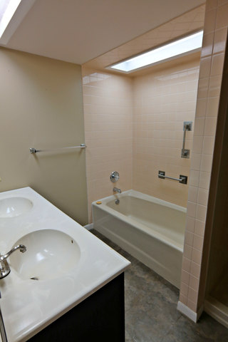 3516 Lily Pond Road Woodstock, IL 60098 - Photo 16 of 20 a bathroom with a tub and a sink