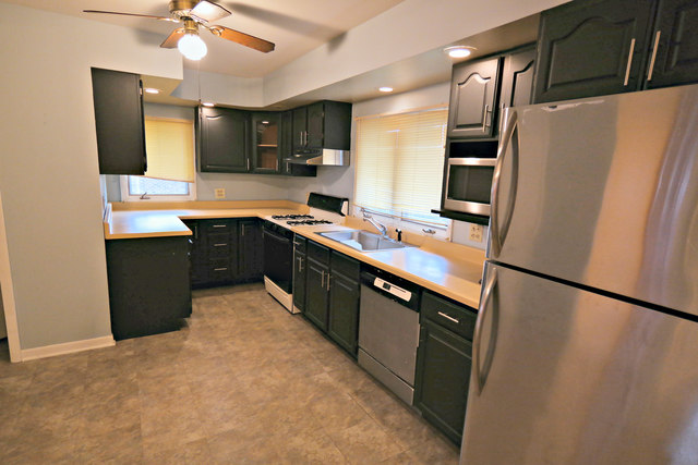 3516 Lily Pond Road Woodstock, IL 60098 - Photo 9 of 20 a kitchen with stainless steel appliances granite countertop a refrigerator a stove a sink dishwasher and a refrigerator