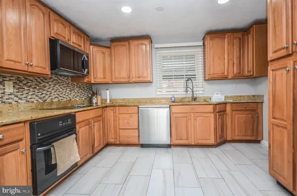 a kitchen with cabinets a sink and appliances