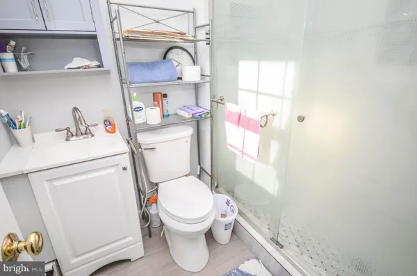 a bathroom with a sink toilet vanity and window