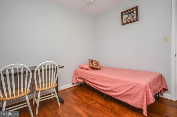 a bedroom with a bed and a chair