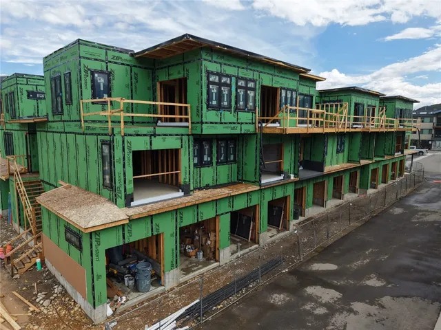a view of a house with wooden floor fence and a balcony
