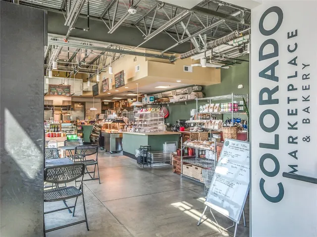 a view of a house with a large window and wooden fence