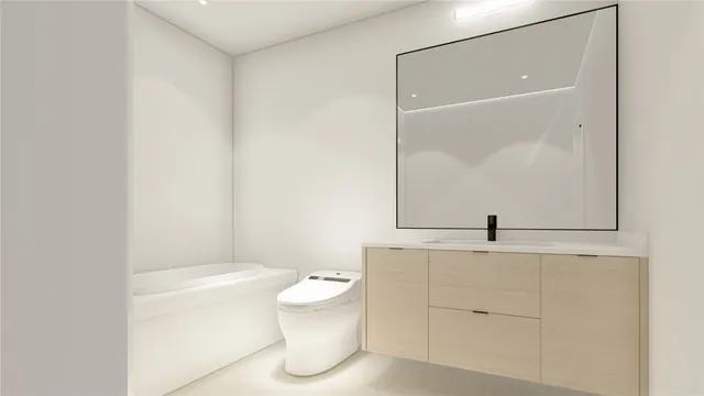 a bathroom with a granite countertop sink mirror vanity and toilet