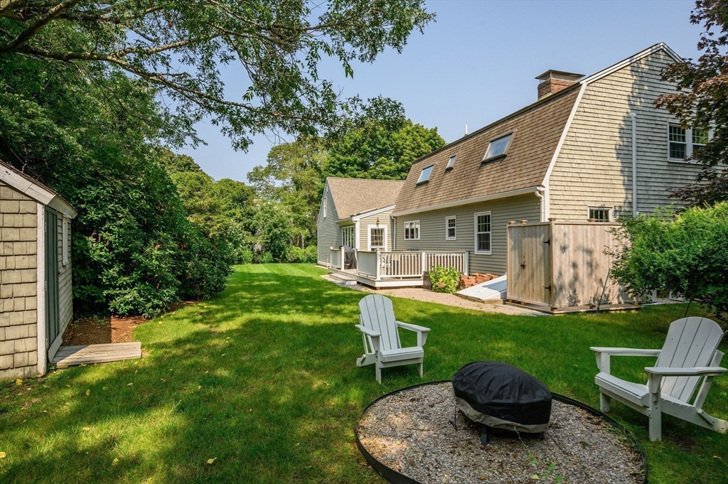 17 Cedar Point Circle Barnstable, MA 02632 - Photo 35 of 41 a view of a chair and table in backyard of the house