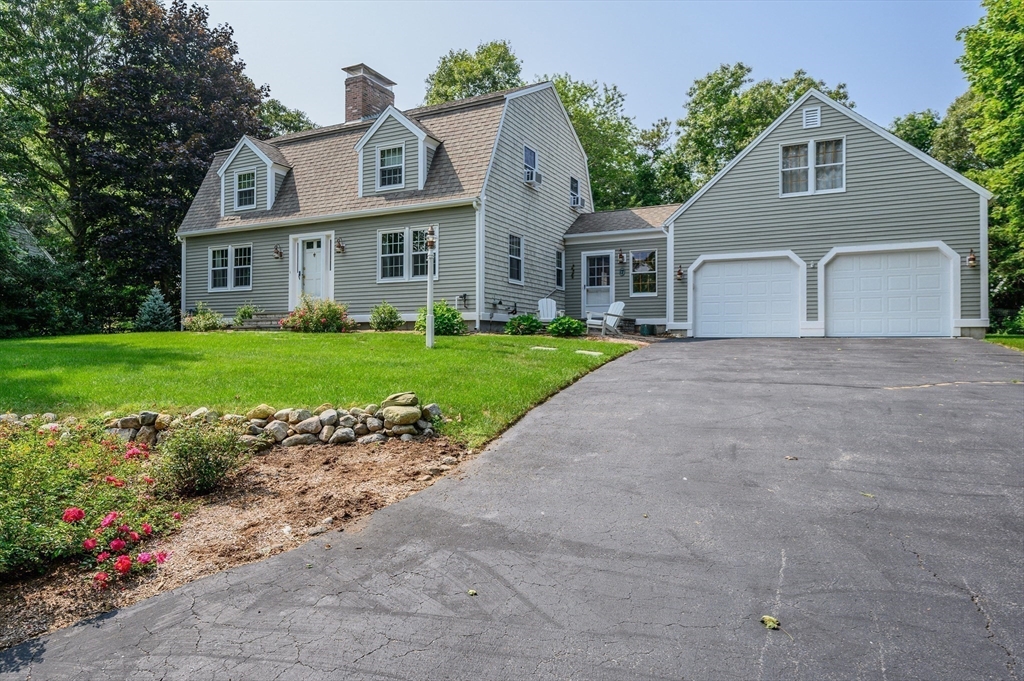 17 Cedar Point Circle Barnstable, MA 02632 - Photo 4 of 41 a front view of a house with a yard and garage