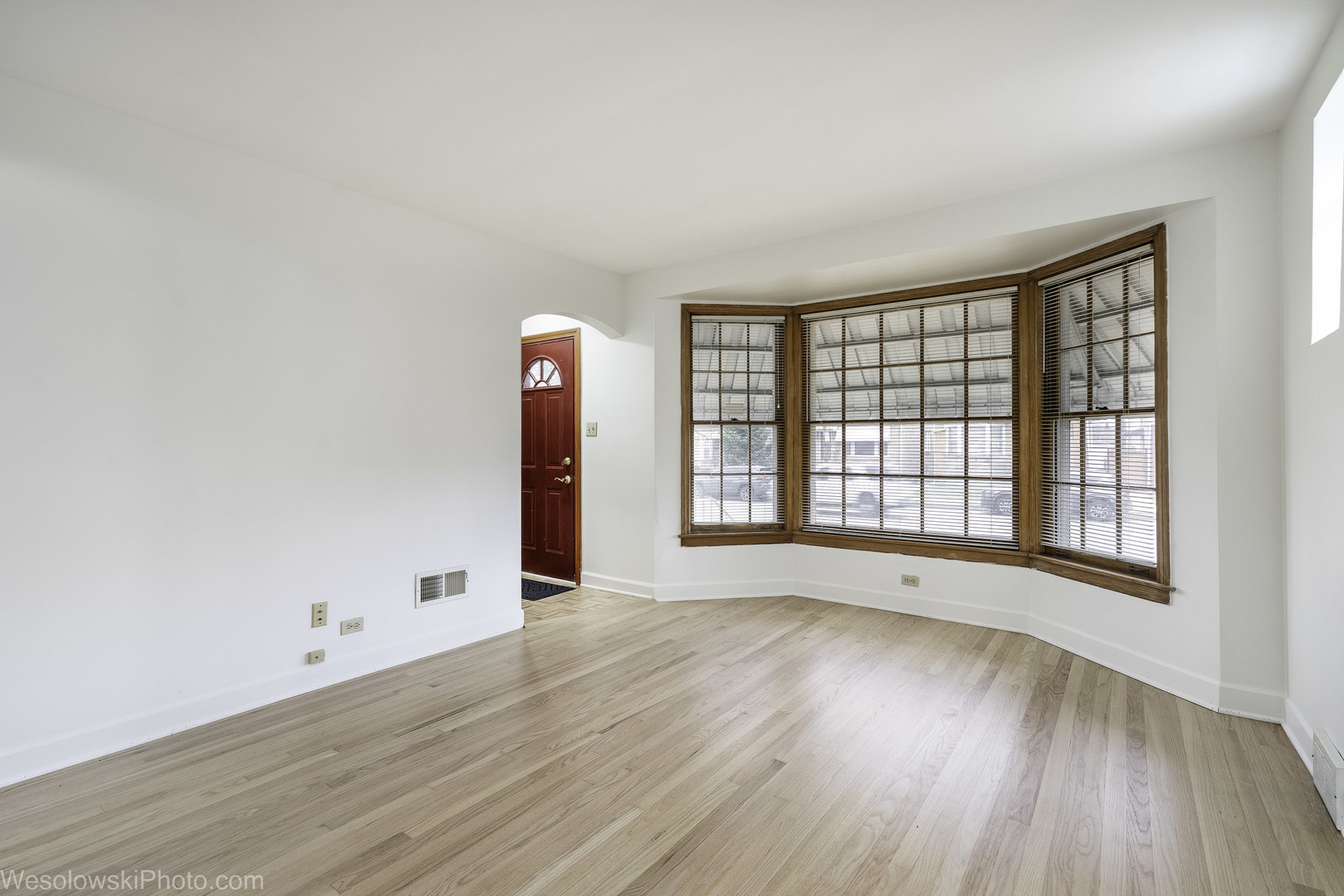 5944 West Foster Avenue Chicago, IL 60630 - Photo 4 of 21 an empty room with wooden floor and windows