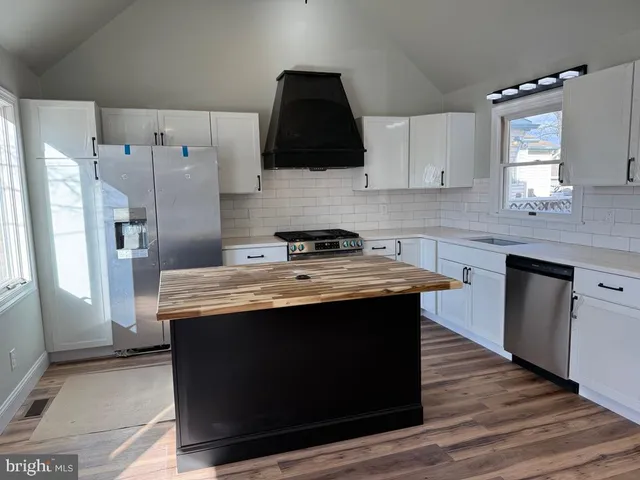 a kitchen with stainless steel appliances granite countertop a stove a sink dishwasher and a refrigerator