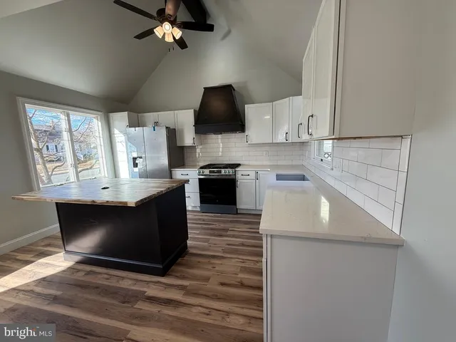 a kitchen with a stove and a refrigerator
