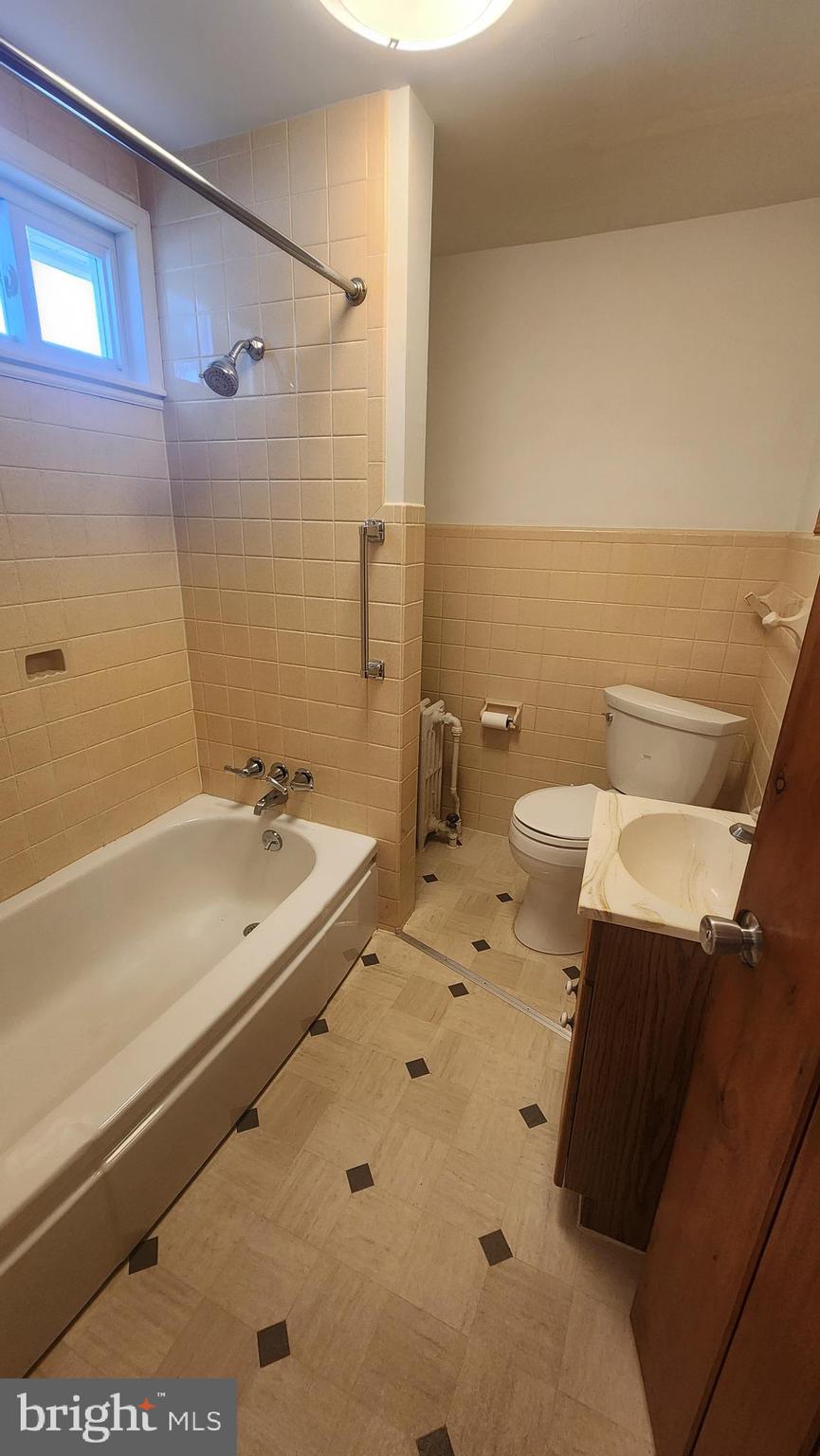 60 Pitman Avenue, Unit 60 Pitman, NJ 08071 - Photo 9 of 12 a bathroom with a sink a toilet and shower