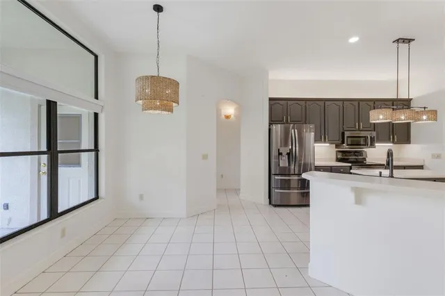a kitchen with stainless steel appliances granite countertop a refrigerator and a stove top oven