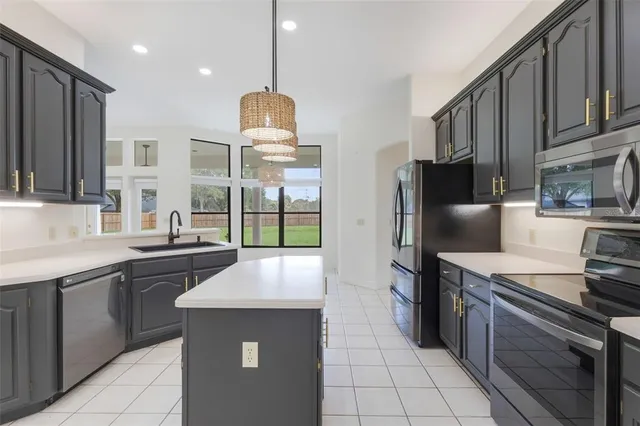 a kitchen with stainless steel appliances a sink stove and refrigerator