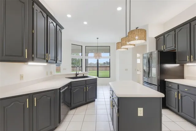 a kitchen with stainless steel appliances a sink stove and refrigerator