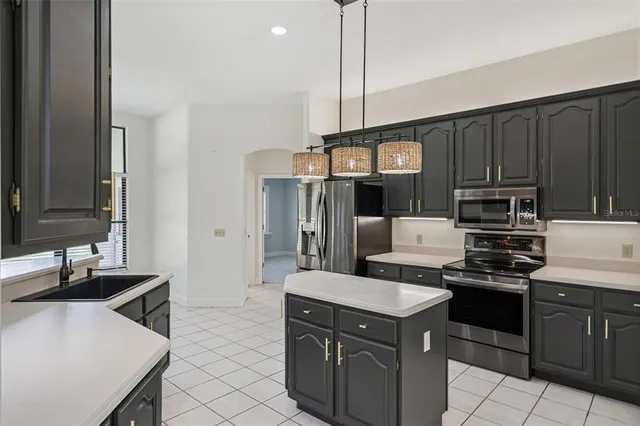 a kitchen with a sink a stove and refrigerator