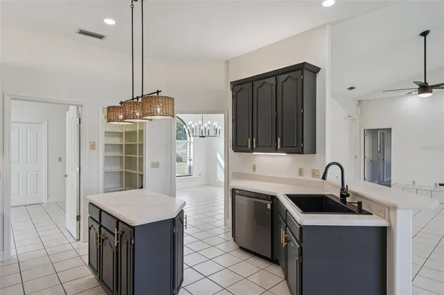 a kitchen with a sink a stove and a wooden floor