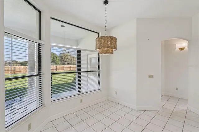 a bathroom with a tub a double vanity sink and a window