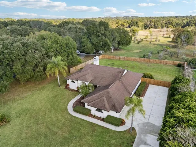 an aerial view of a house with garden space and outdoor seating
