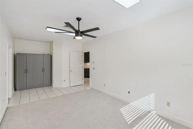 a view of a patio with table and chairs and floor to ceiling window