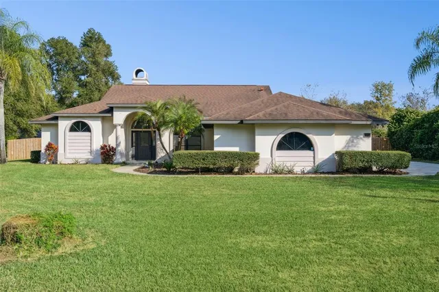 a front view of house with yard and trees