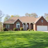 a front view of house with yard and green space