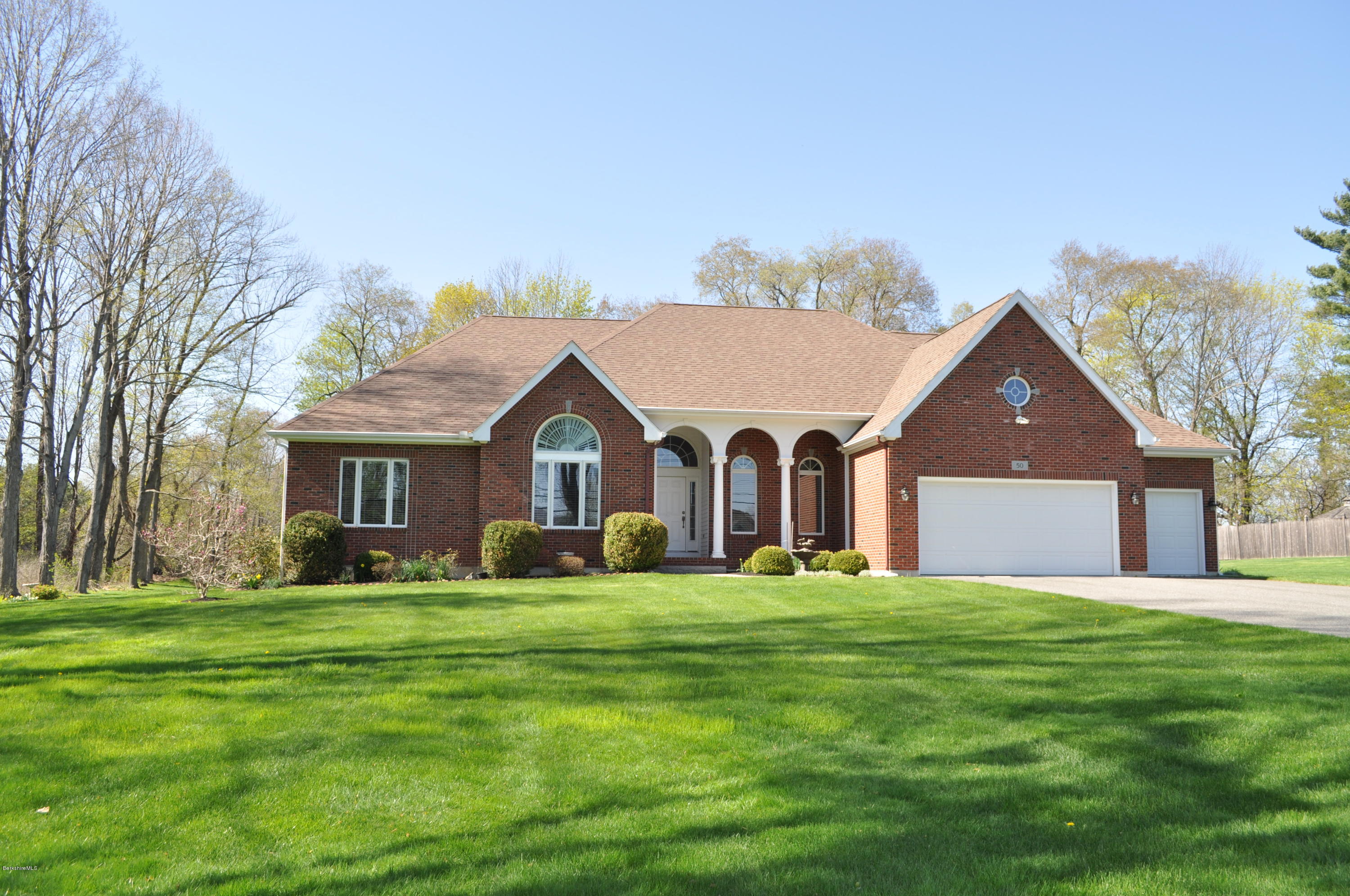 a front view of house with yard and green space