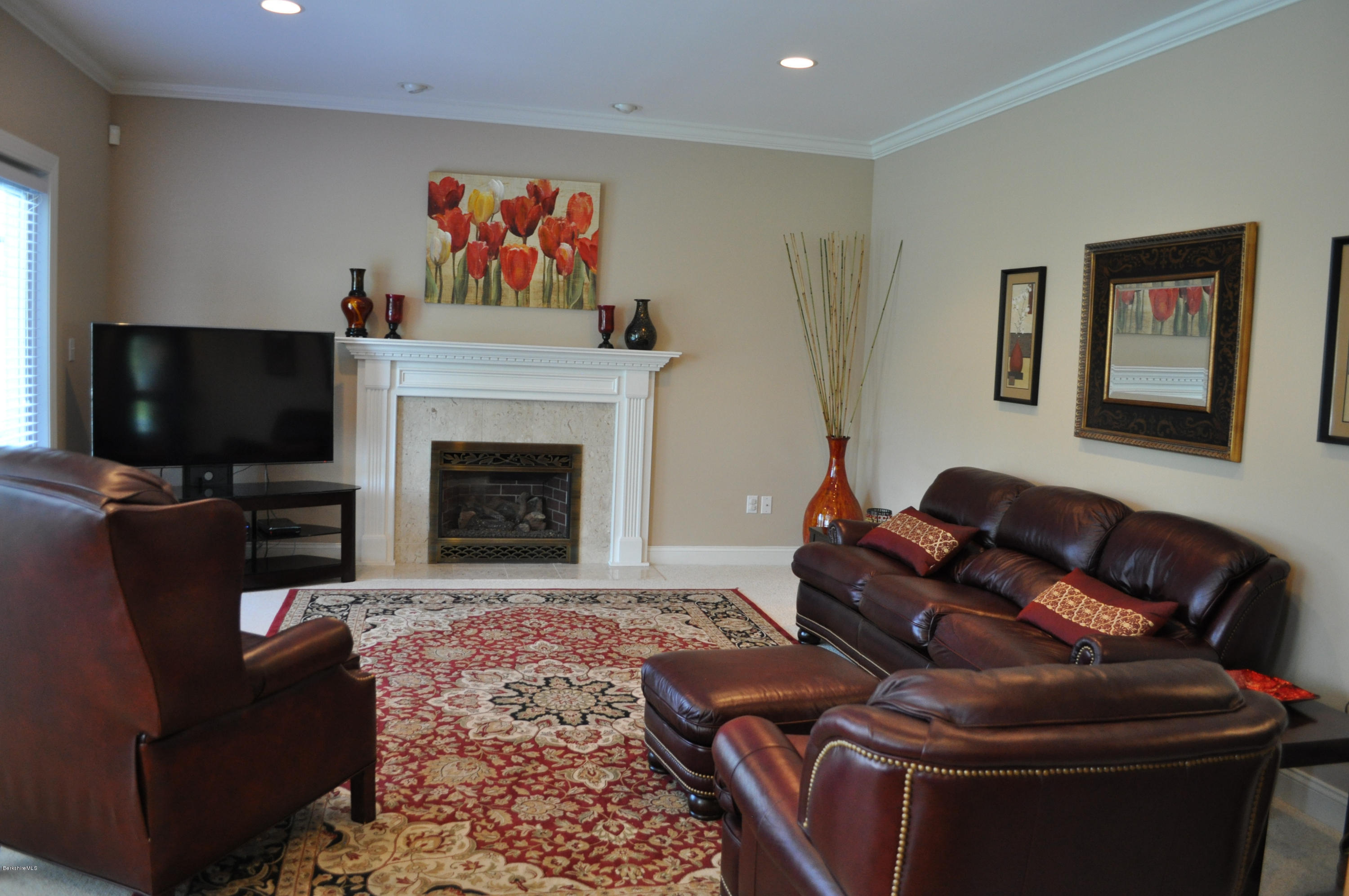 50 Stockbridge Road Lee, MA 01238 - Photo 13 of 27 a living room with furniture a flat screen tv and a fireplace
