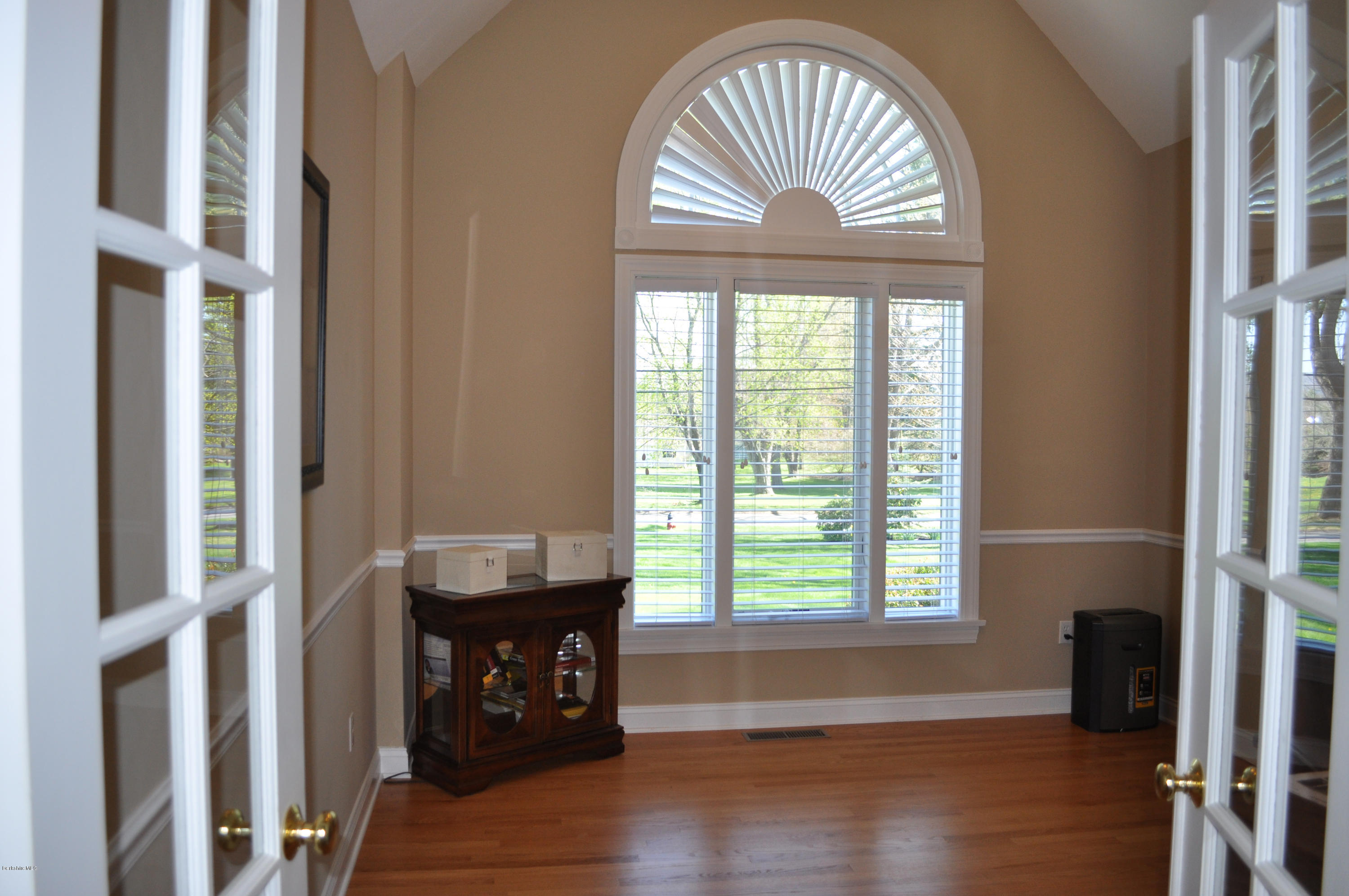 50 Stockbridge Road Lee, MA 01238 - Photo 24 of 27 an empty room with wooden floor fan and a window