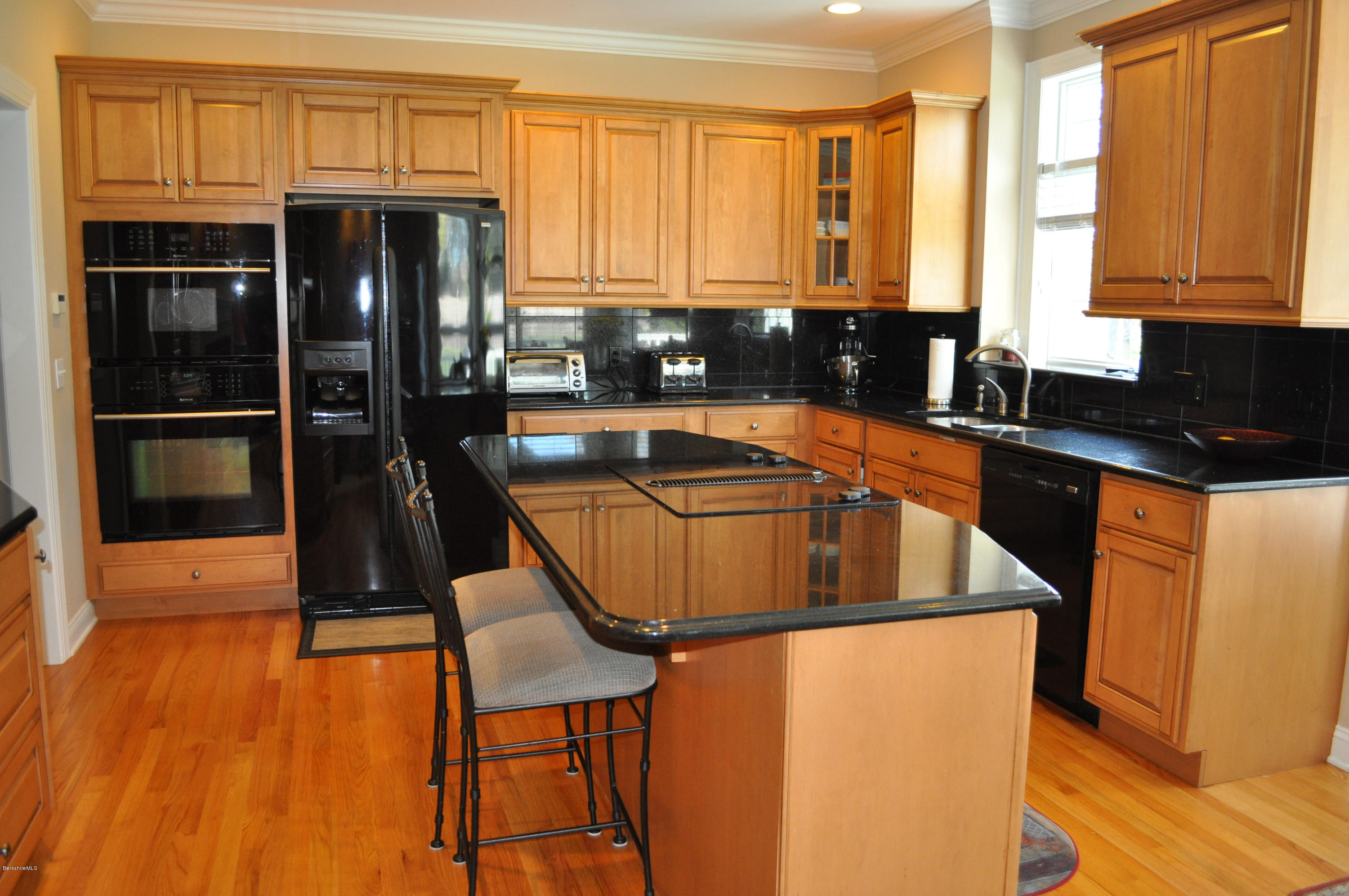 50 Stockbridge Road Lee, MA 01238 - Photo 10 of 27 a kitchen with stainless steel appliances granite countertop a stove a refrigerator and a microwave