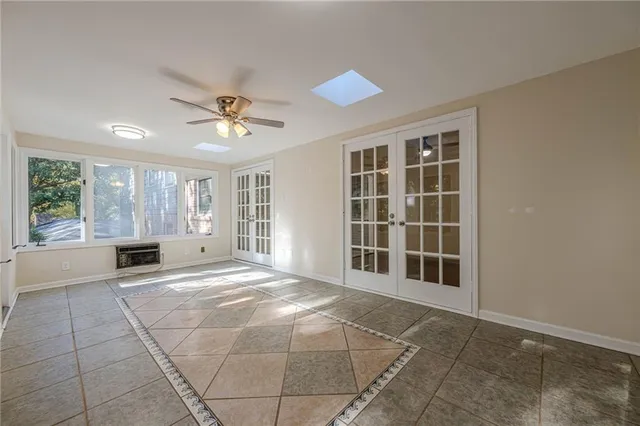 a view of a livingroom with a ceiling fan and window