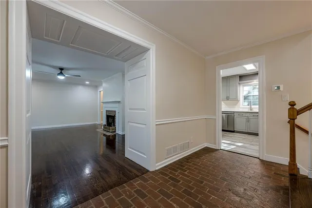 a view of a hallway view with wooden floor and kitchen