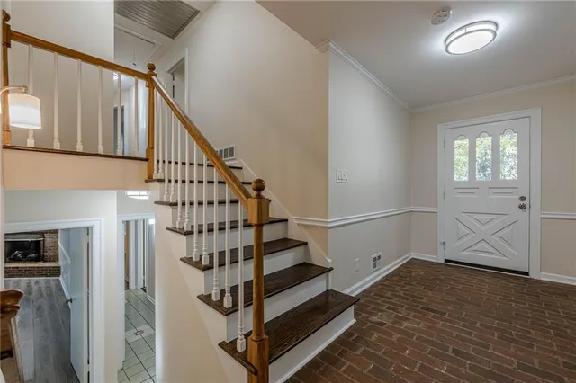 a view of entryway with wooden floor and stairs