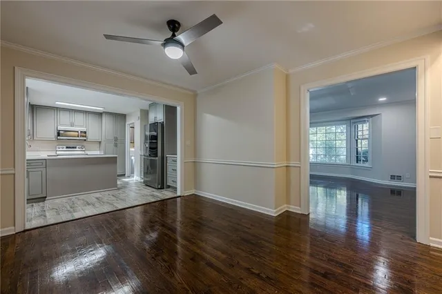 a view of a kitchen with wooden floor a kitchen view and a window