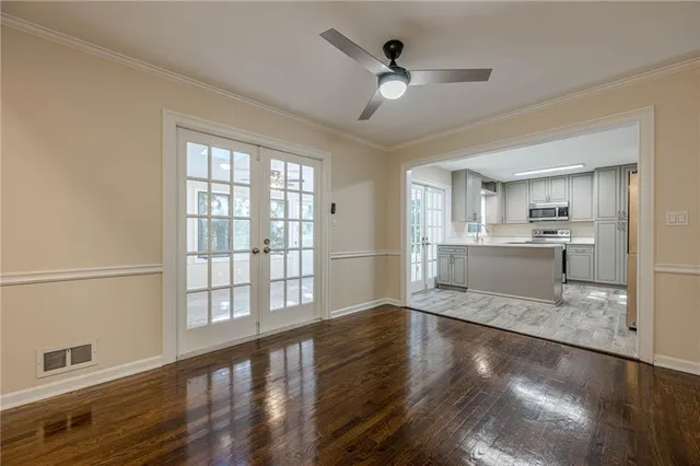 a view of a kitchen with wooden floor and a kitchen