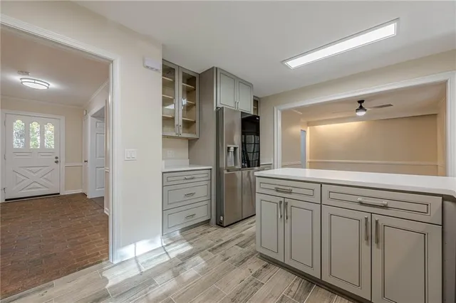 a kitchen with white cabinets and stainless steel appliances