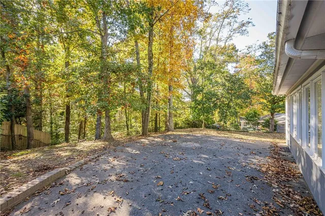 a view of backyard with large trees
