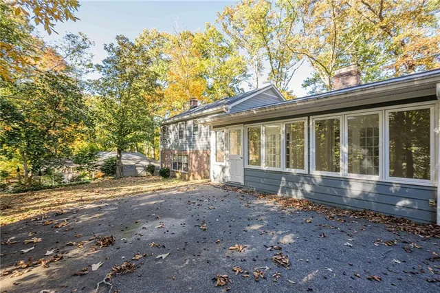 a view of a house with a yard and sitting area