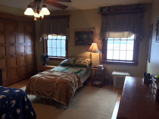 12663 West Offner Road Manhattan, IL 60442 - Photo 21 of 25 a bedroom with a bed and a chandelier