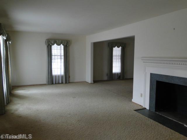 1406 Coventry Road High Point, NC 27262 - Photo 5 of 13 Living Room. Large living area with fireplace with formal dining on right