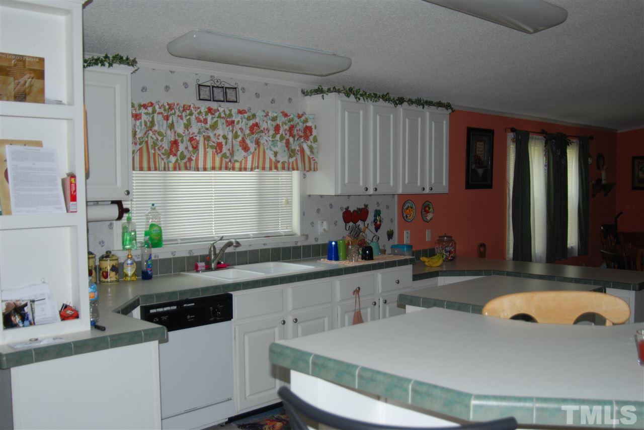 1298 O B J Road Dunn, NC 28334 - Photo 2 of 24 a kitchen with a sink cabinets and window