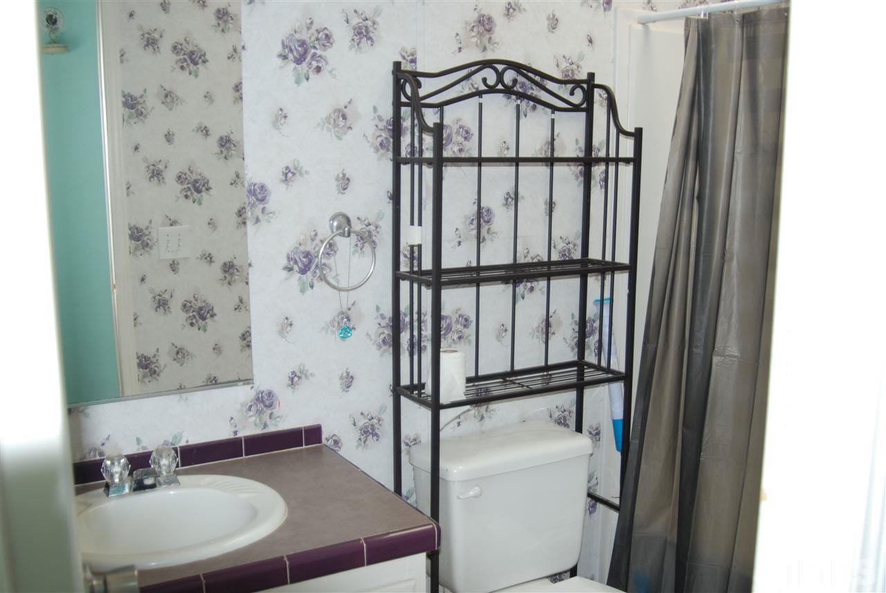 1298 O B J Road Dunn, NC 28334 - Photo 11 of 24 a bathroom with a sink and a mirror