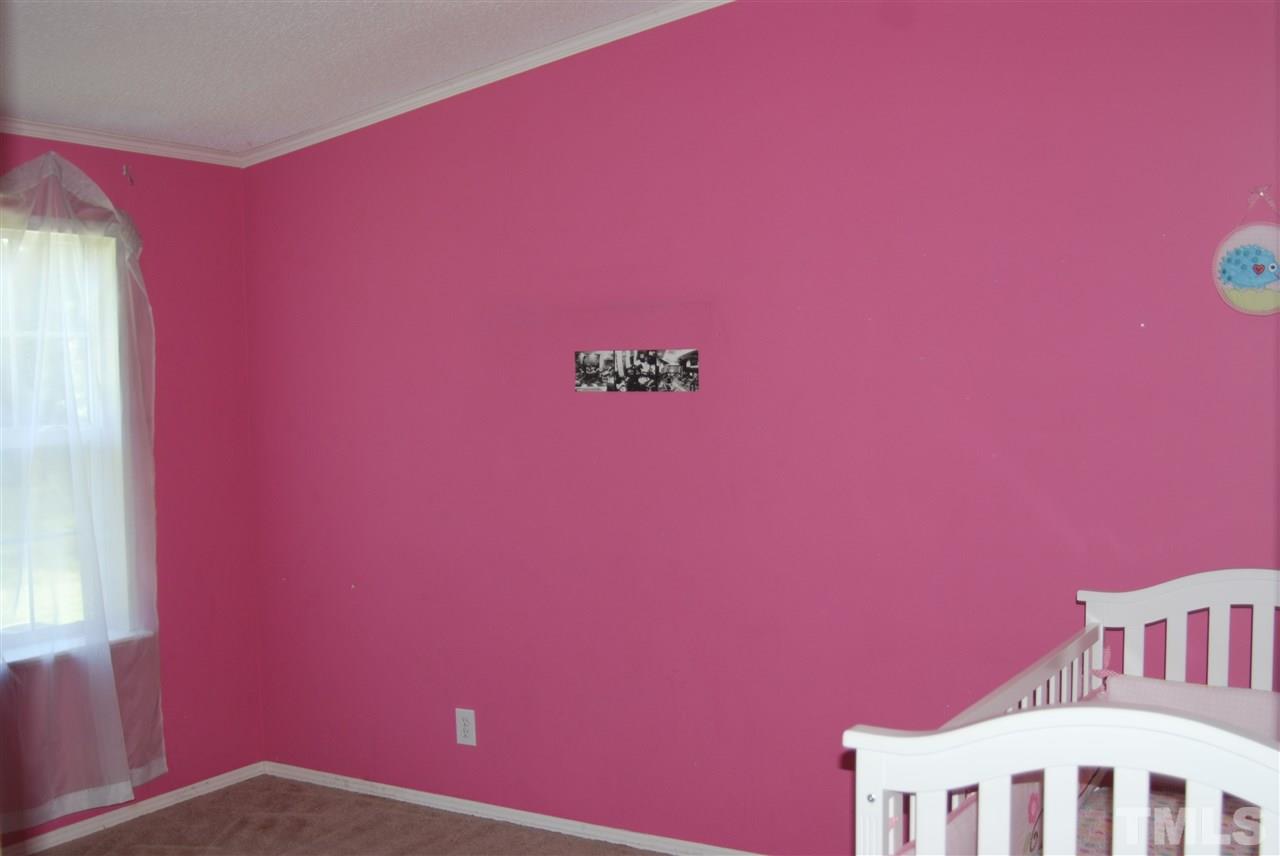 1298 O B J Road Dunn, NC 28334 - Photo 12 of 24 a view of a livingroom with an empty space and a window