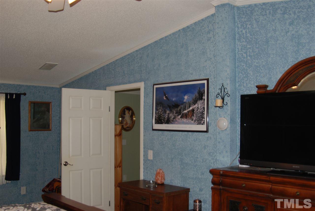 1298 O B J Road Dunn, NC 28334 - Photo 13 of 24 a living room with furniture and a flat screen tv