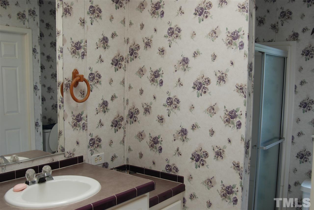 1298 O B J Road Dunn, NC 28334 - Photo 17 of 24 a bathroom with a sink and a mirror