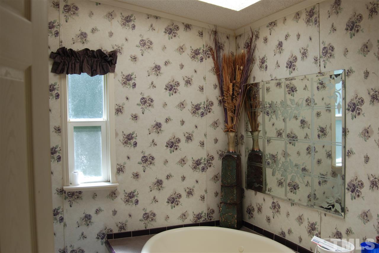 1298 O B J Road Dunn, NC 28334 - Photo 18 of 24 a bathroom with a toilet and a shower curtain